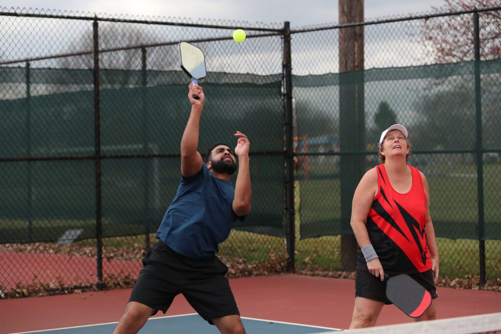 pickleball overhead during a mixed doubles game.