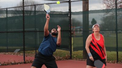 pickleball overhead during a mixed doubles game.