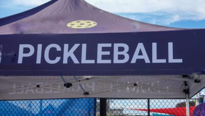 A tent that says pickleball and has a pickleball logo